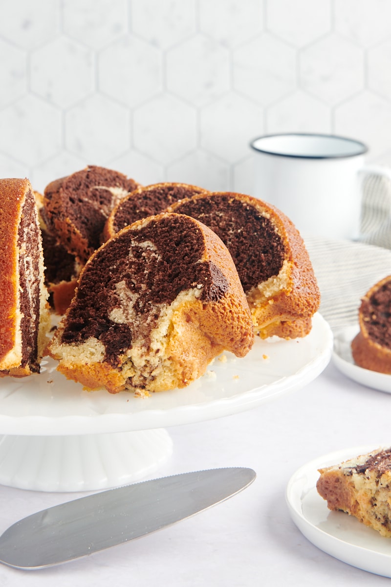 sliced Marble Bundt Cake on a white cake stand