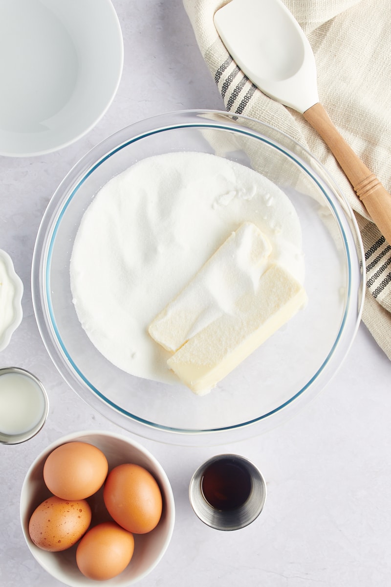 overhead view of butter and sugar in a glass mixing bowl