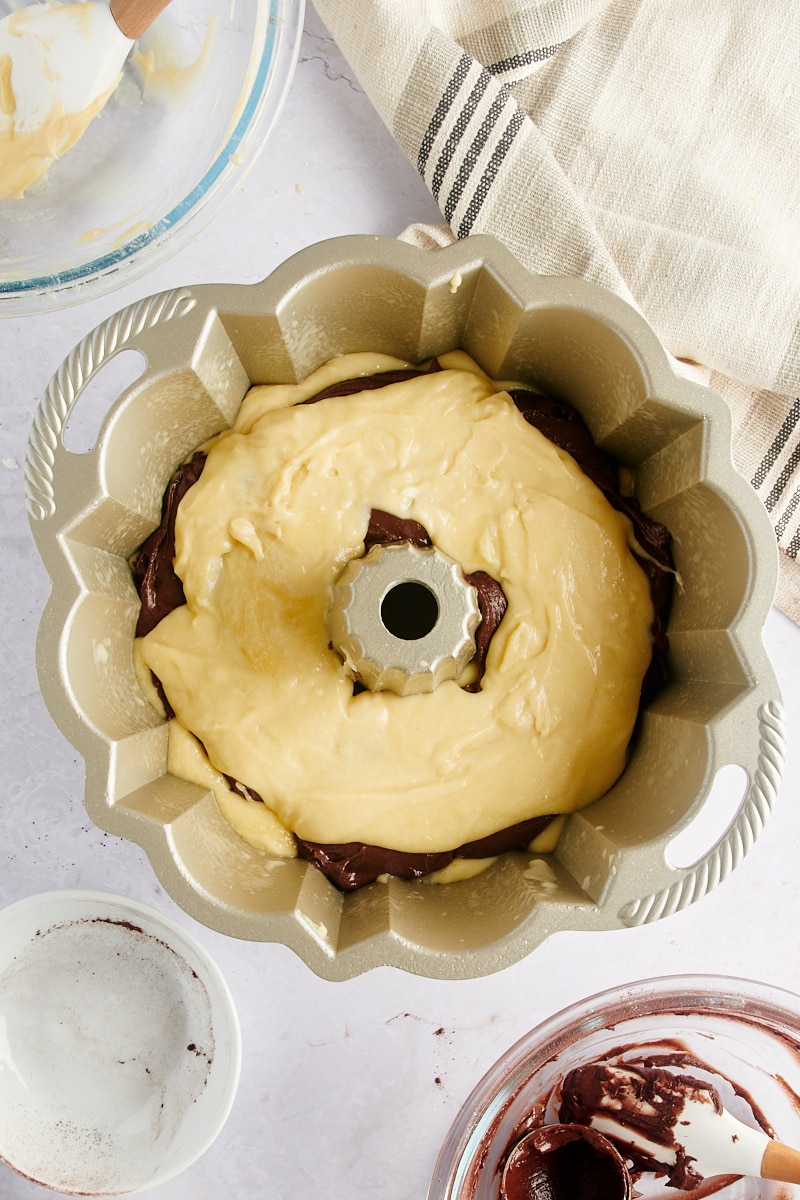 overhead view of three layers of Marble Bundt Cake batter in a Bundt pan