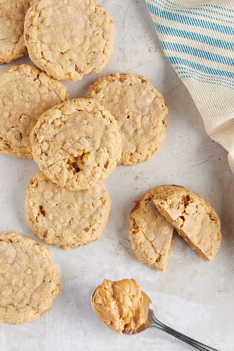 Outrageous Peanut Butter Cookies on tabletop with spoonful of peanut butter
