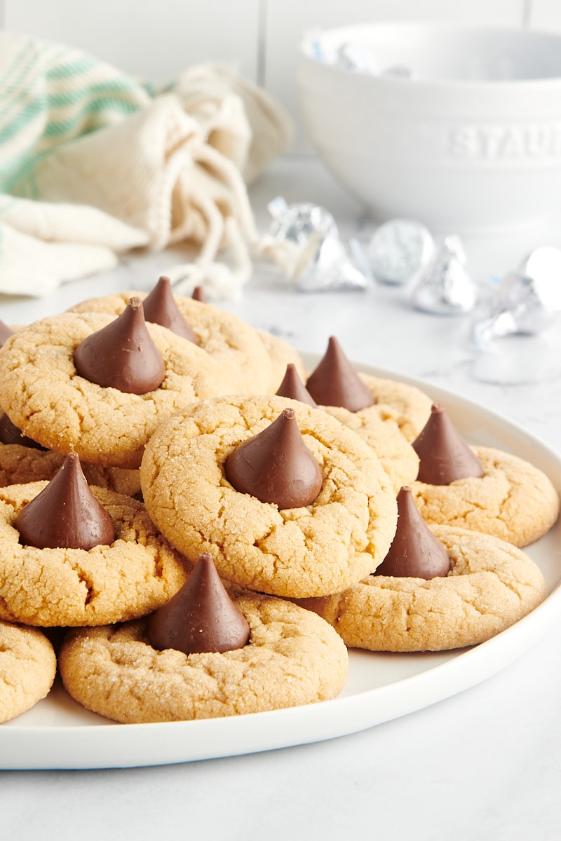 Peanut Butter Blossoms piled on a large white plate