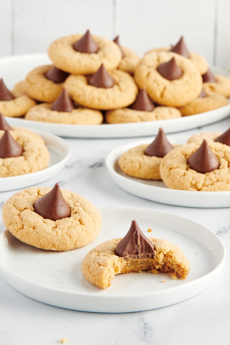 Peanut Butter Blossoms on small white plates and a large white tray