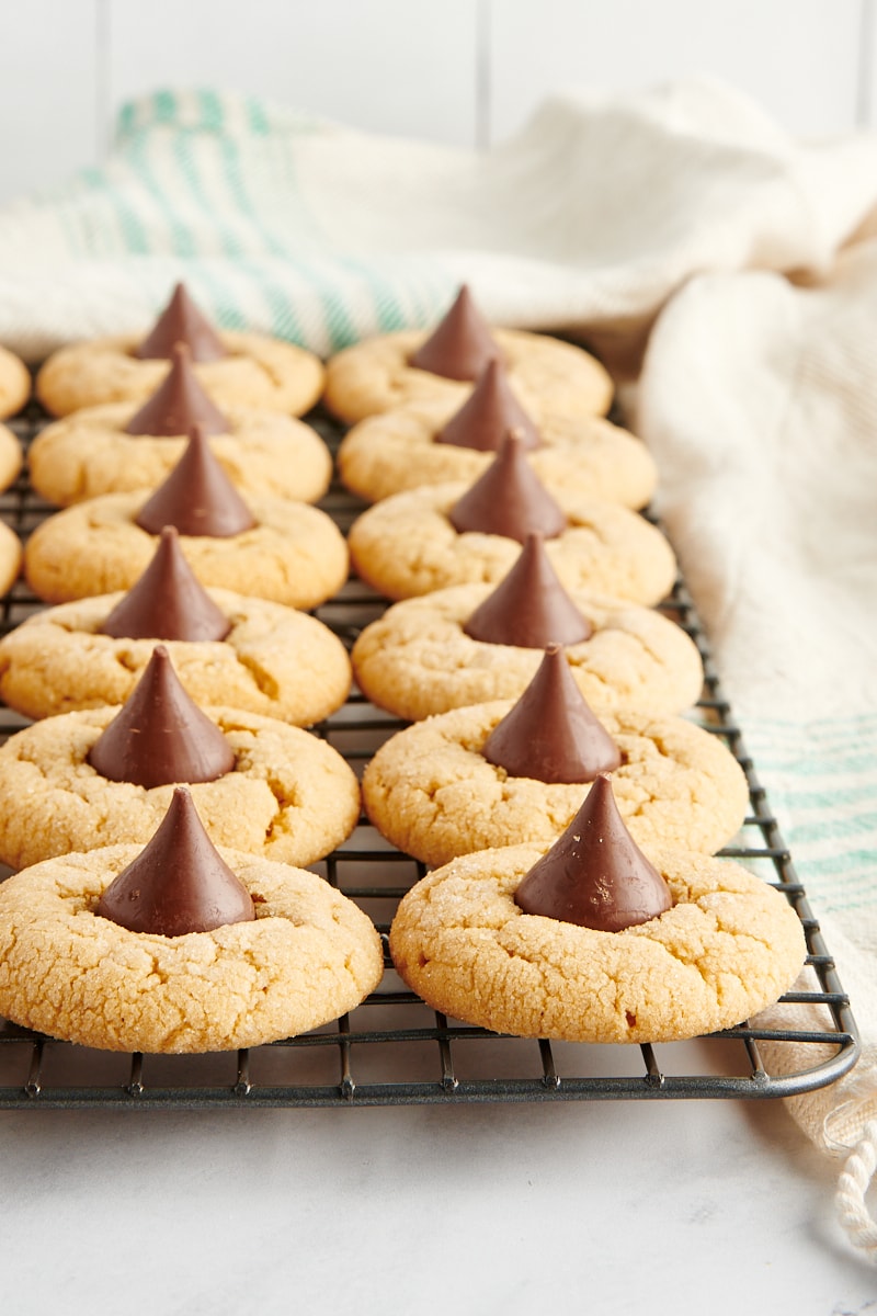 Peanut Butter Blossoms lined up on a wire cooling rack