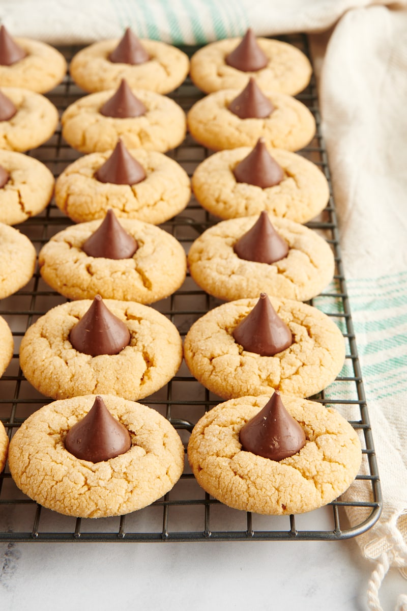 Peanut Butter Blossoms lined up on a wire cooling rack