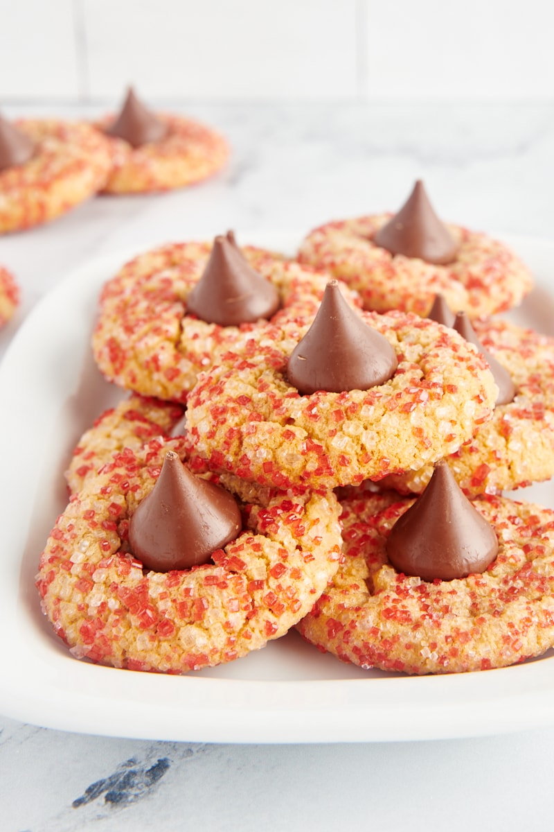 Peanut Butter Blossoms rolled in red sanding sugar and served on a rectangular white tray