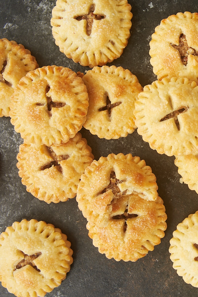 overhead view of Pecan Hand Pies piled on a dark surface