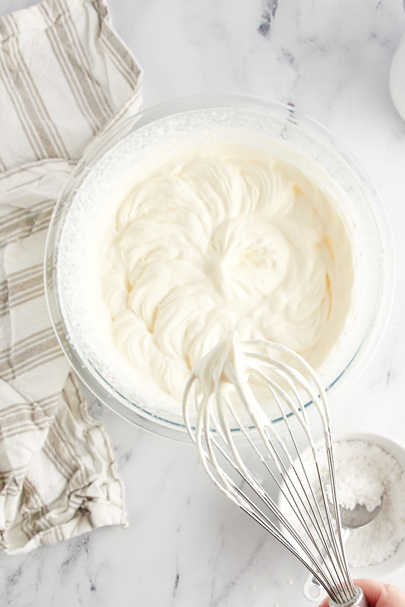 soft-peak whipped cream on a mixer's whisk attachment