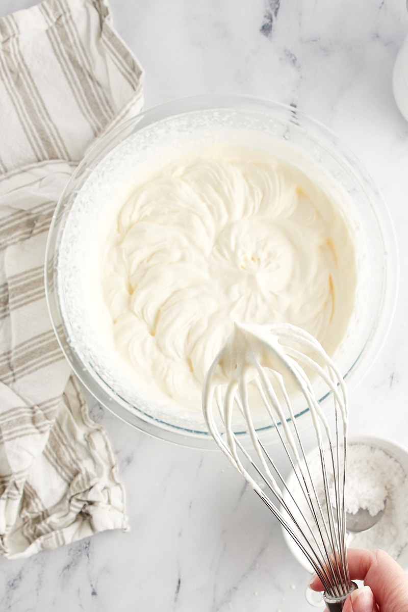 stiff-peak whipped cream on a mixer's whisk attachment