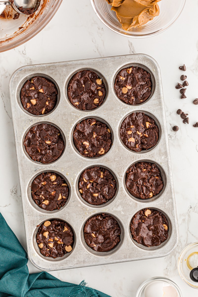 Overhead view of brownie batter in muffin tin