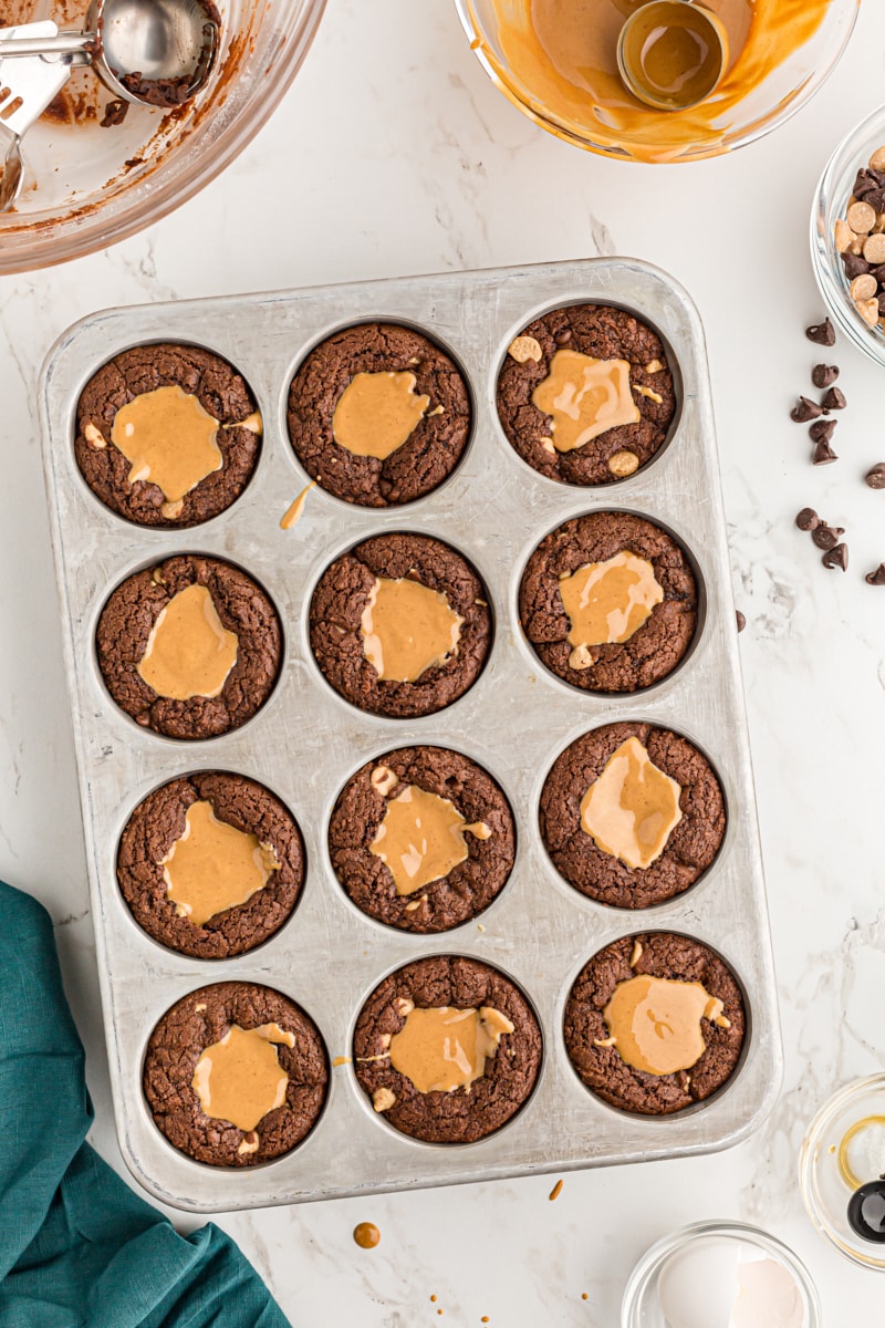 Overhead view of brownies in muffin tin filled with peanut butter