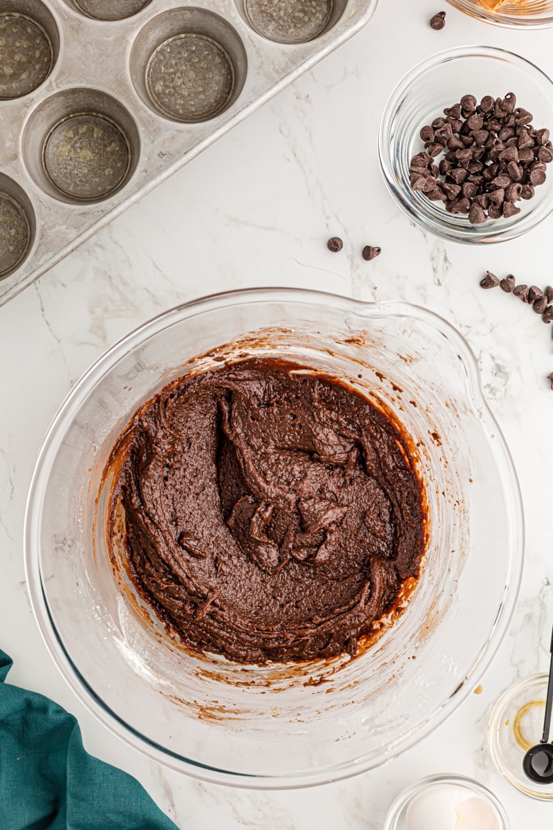 Overhead view of brownie batter in glass bowl