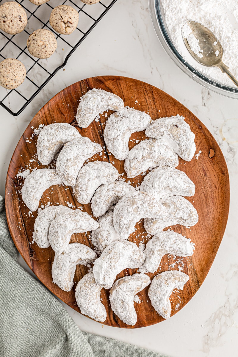 Overhead view of hazelnut crescent cookies on wood tray