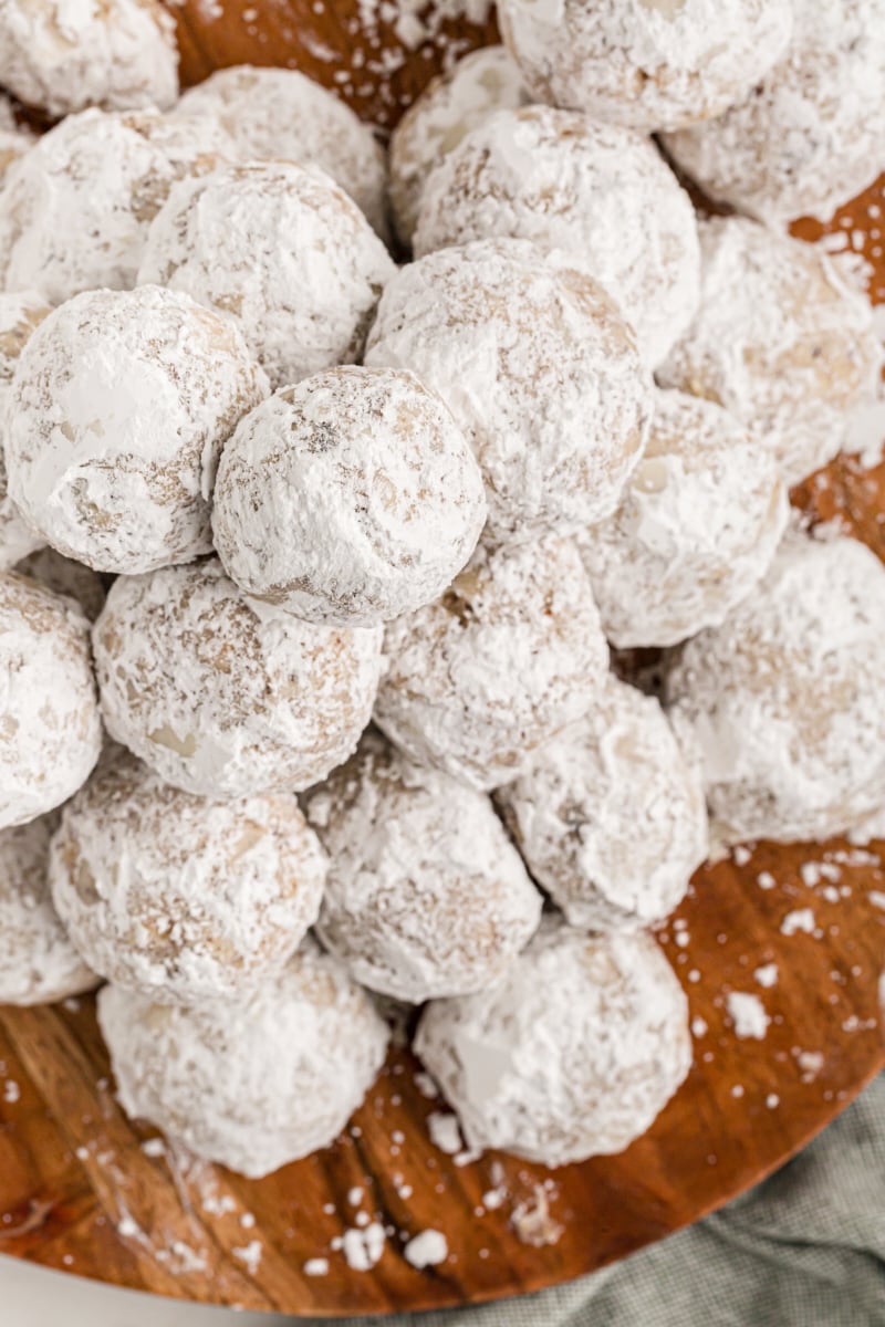 Overhead view of round hazelnut cookies on wooden plate