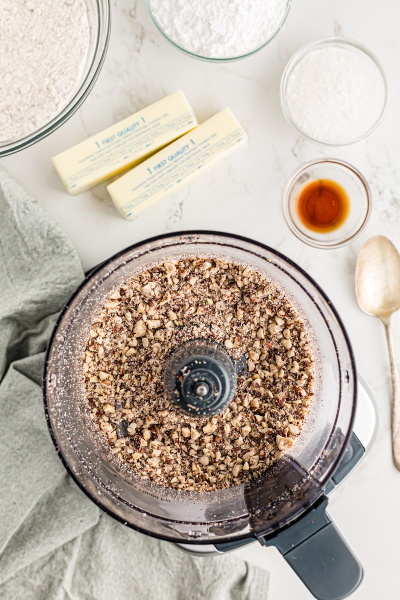 Overhead view of ground hazelnuts in food processor