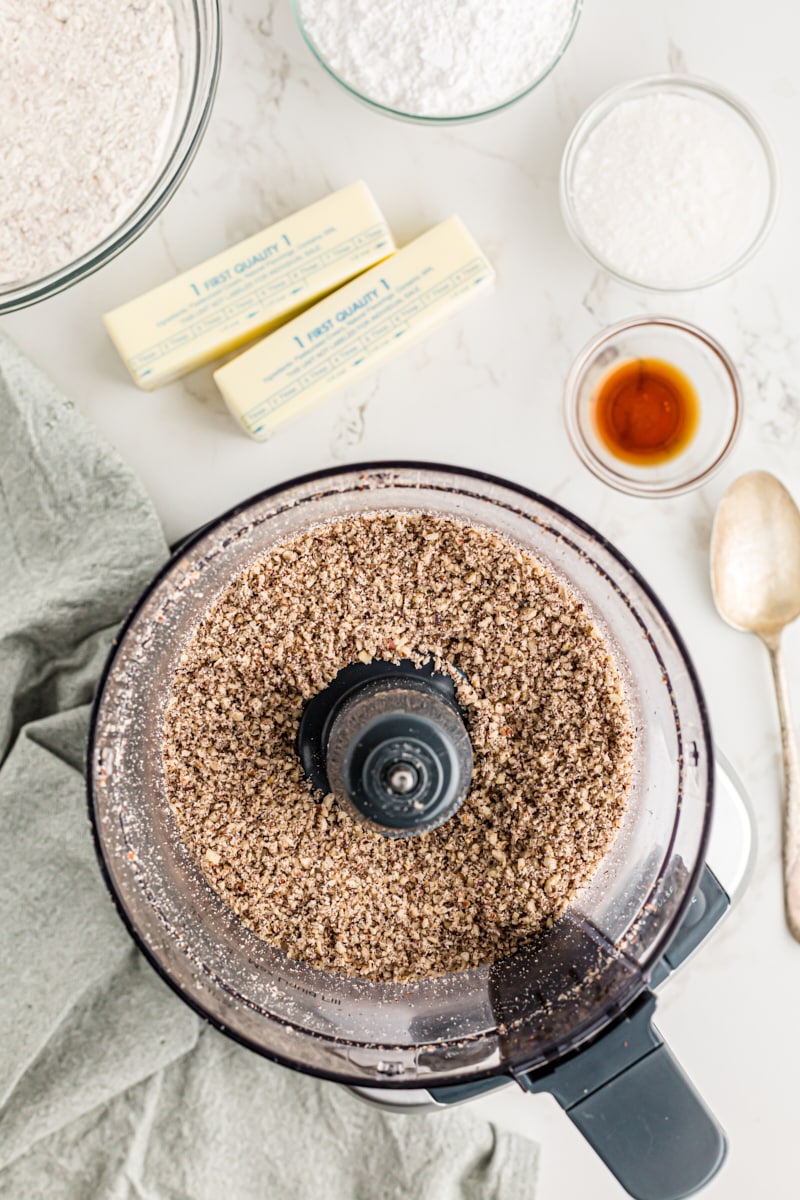 Overhead view of ground hazelnuts in food processor