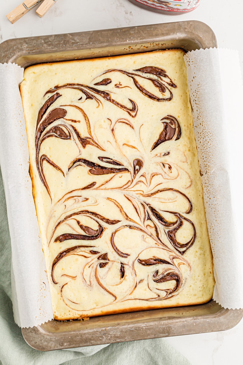 Overhead view of Nutella swirl cheesecake bars in pan