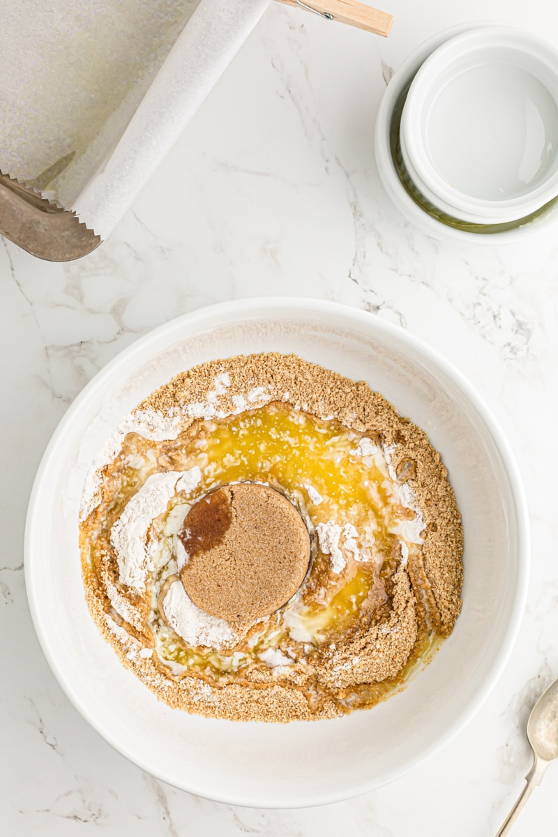 Overhead view of graham cracker crust ingredients in bowl