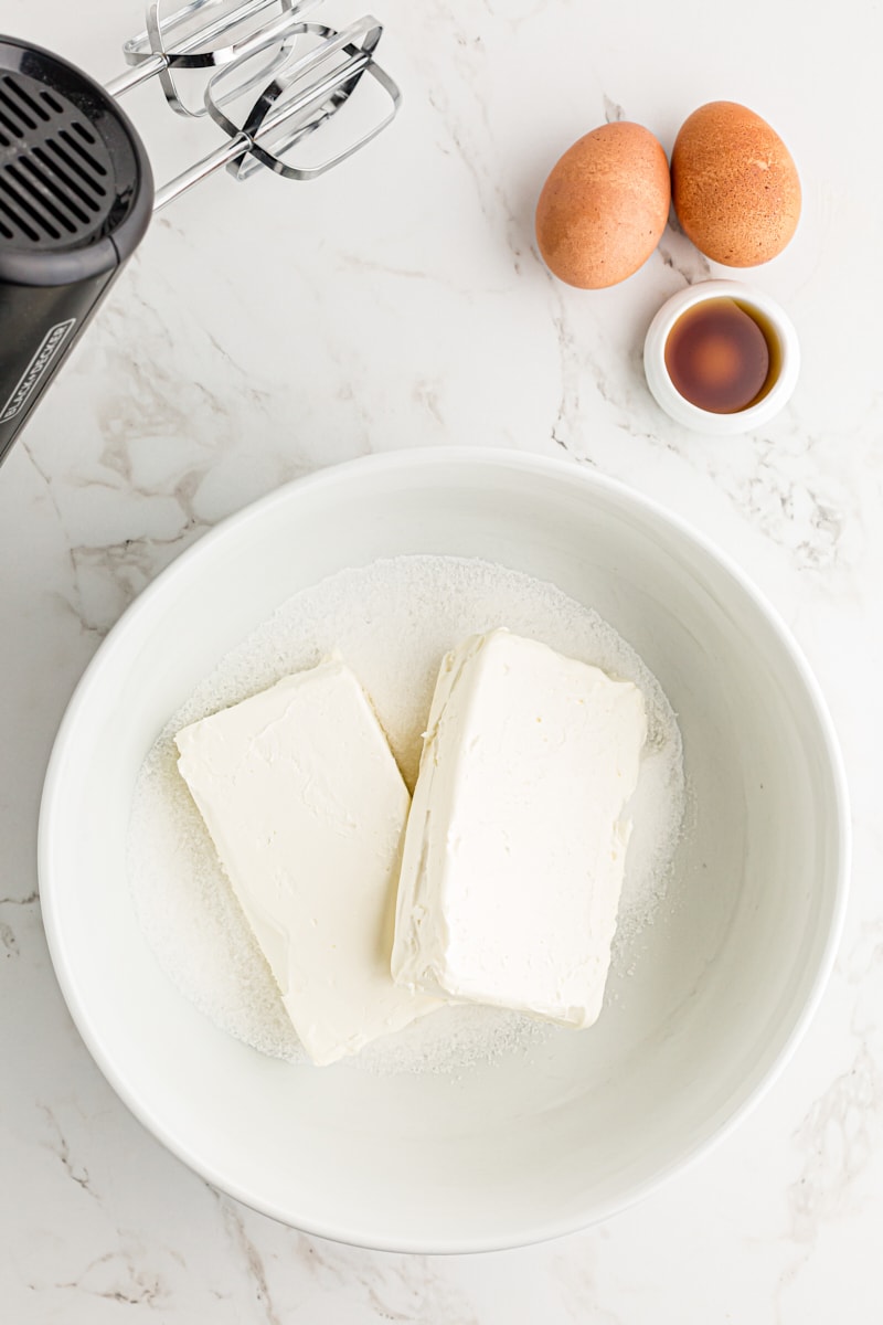 Overhead view of cream cheese and sugar in bowl