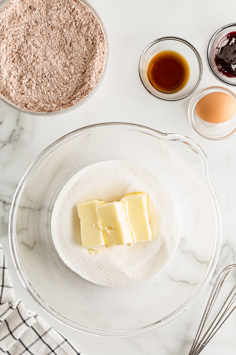 overhead view of butter and sugar in a glass mixing bowl