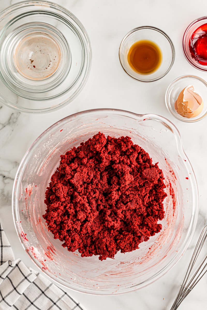 overhead view of mixed Red Velvet Cookie dough in a glass mixing bowl