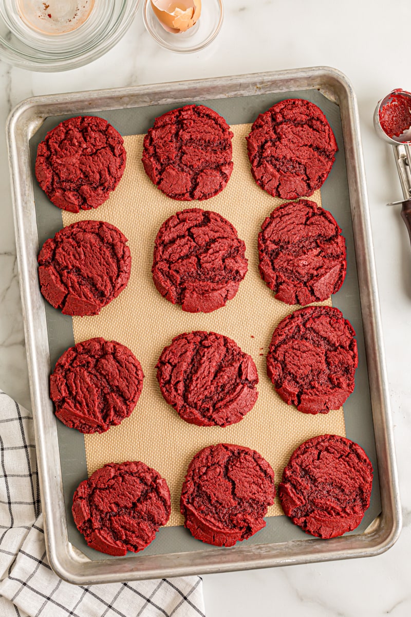 overhead view of freshly baked Red Velvet Cookies on a baking sheet lined with a silicone mat