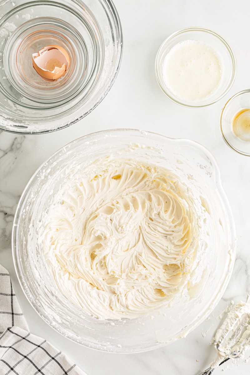 overhead view of cream cheese frosting in a glass mixing bowl
