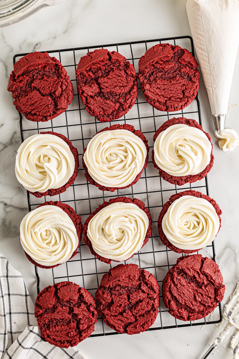 overhead view of frosted and unfrosted Red Velvet Cookies on a wire rack