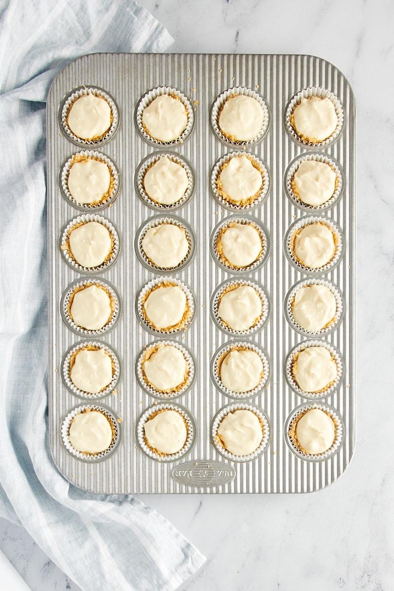 Mini cheesecakes in a mini muffin tin before baking.