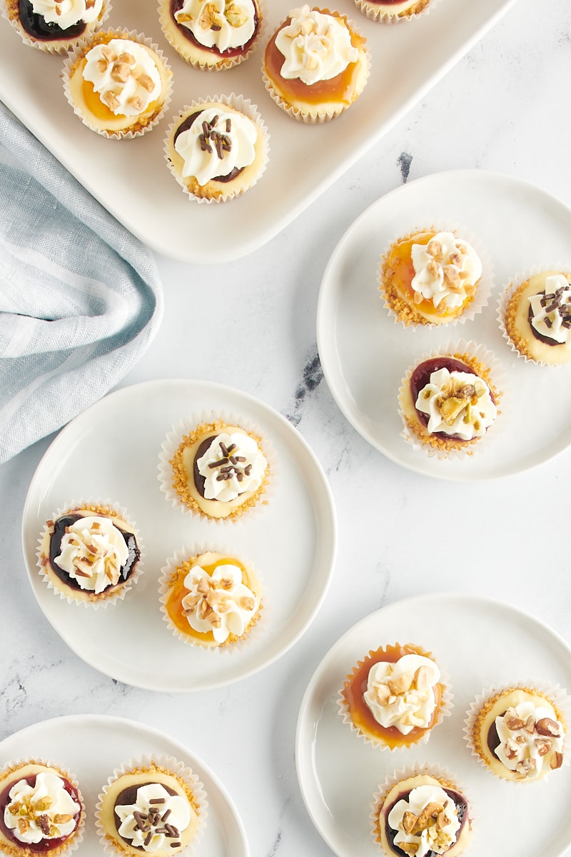 Overhead view of mini cheesecakes on plates.