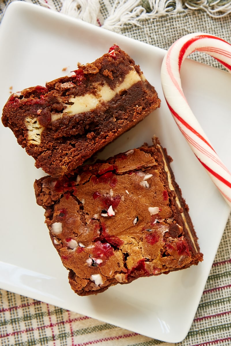 overhead view of two Peppermint Cheesecake Brownies on a square white plate