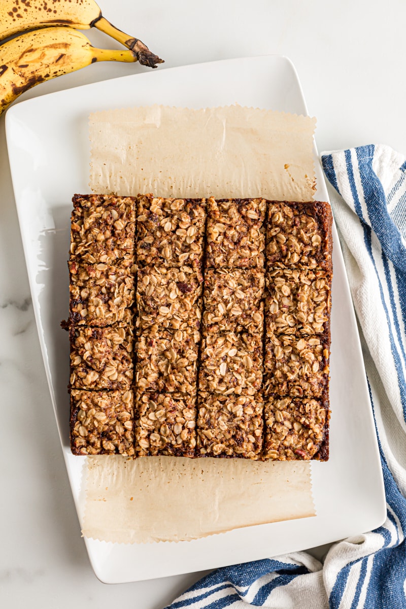 Overhead view of cut banana oatmeal crumb cake on platter