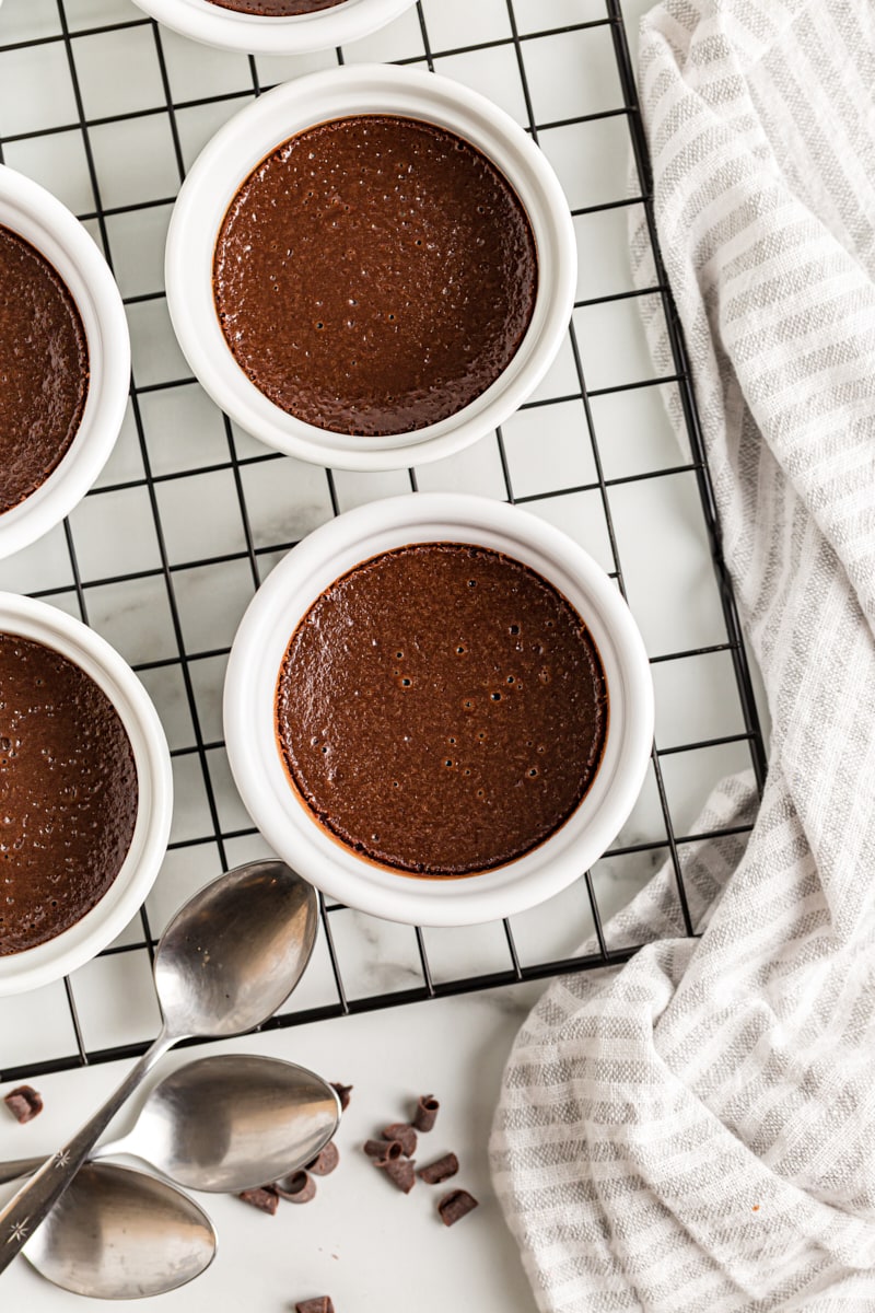 Overhead view of chocolate pots de creme on wire rack