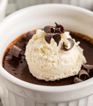 Closeup of pot de creme topped with ice cream and chocolate shavings