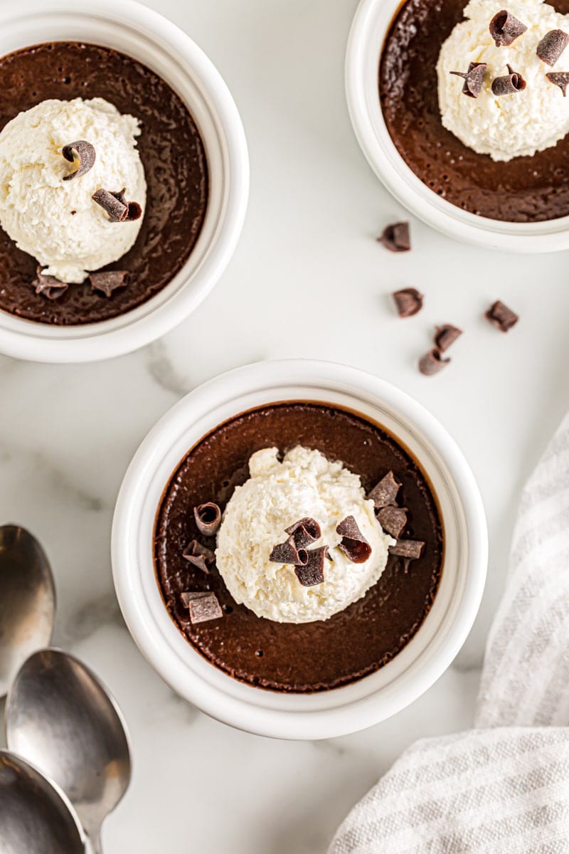 3 pots de creme topped with ice cream and chocolate curls