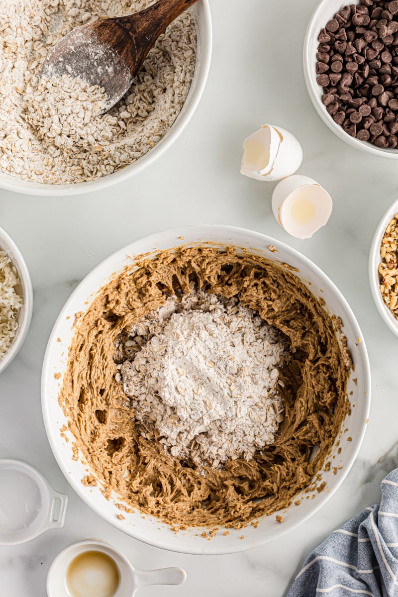 Overhead view of dry ingredients added to cookie dough