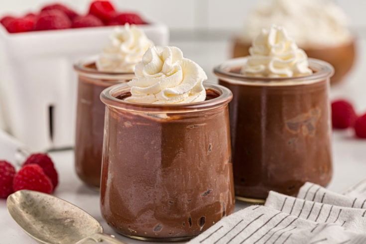 3 jars of chocolate pudding with whipped cream