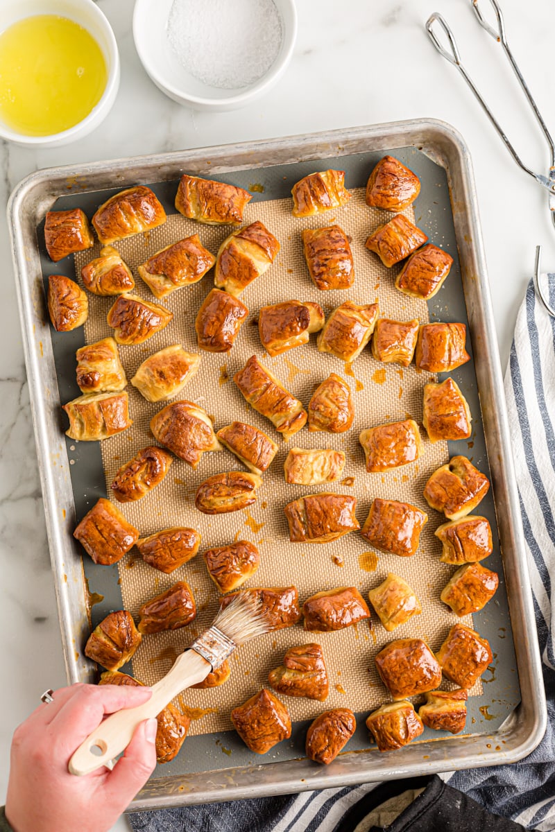 overhead view of freshly baked Pretzel Bites being brushed with melted butter