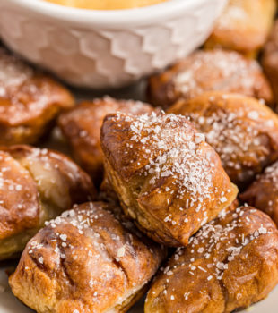 Pretzel Bites on a white plate with a bowl of beer cheese dip