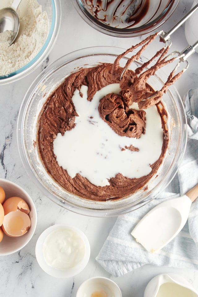 overhead view of buttermilk added to chocolate cake batter