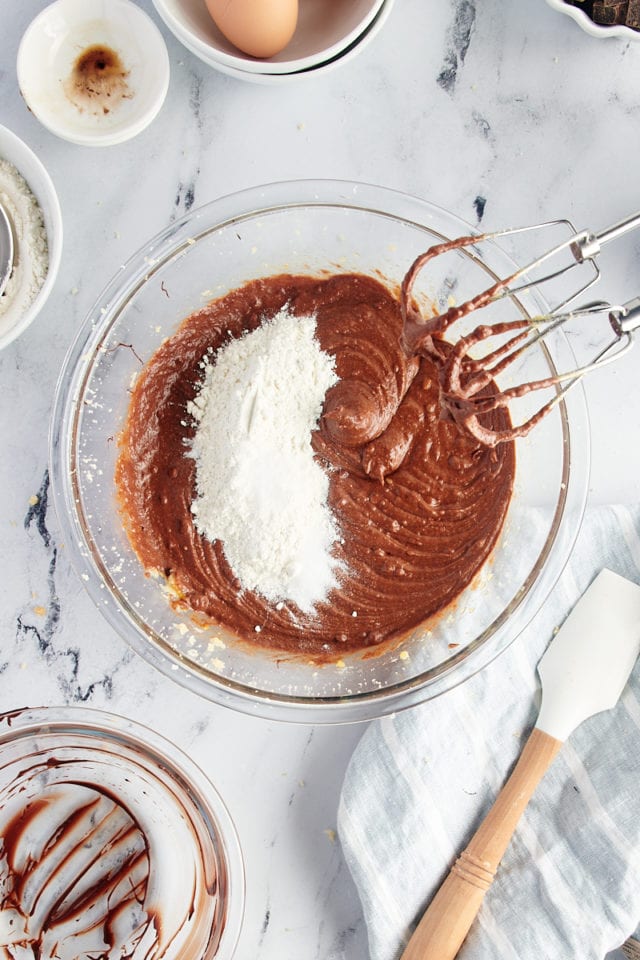 Overhead view of dry ingredients added to brownie batter