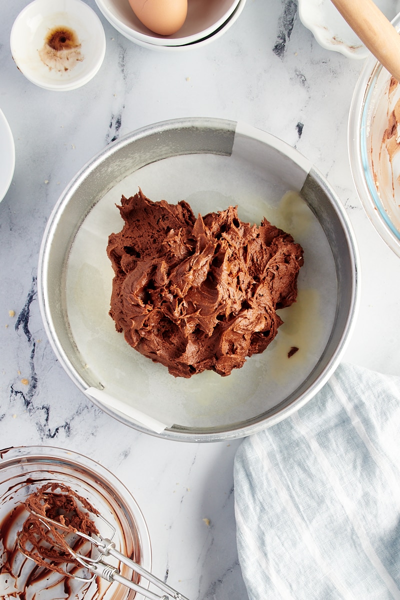 Overhead view of brownie batter in round pan before spreading