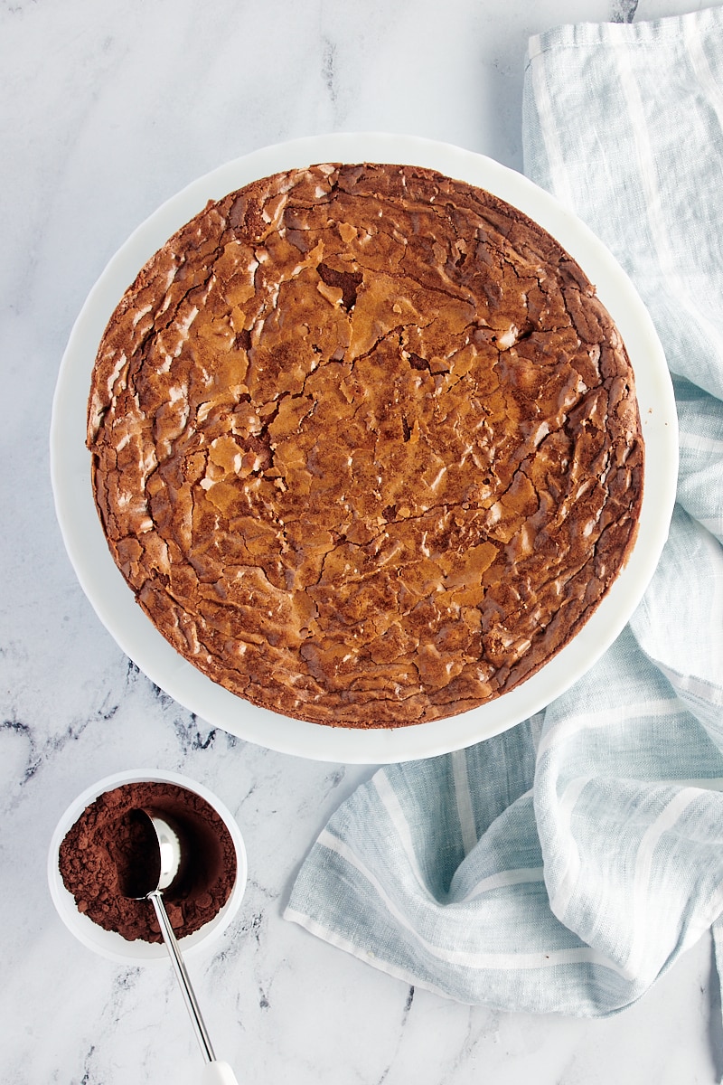 Overhead view of brownie cake and bowl of cocoa powder