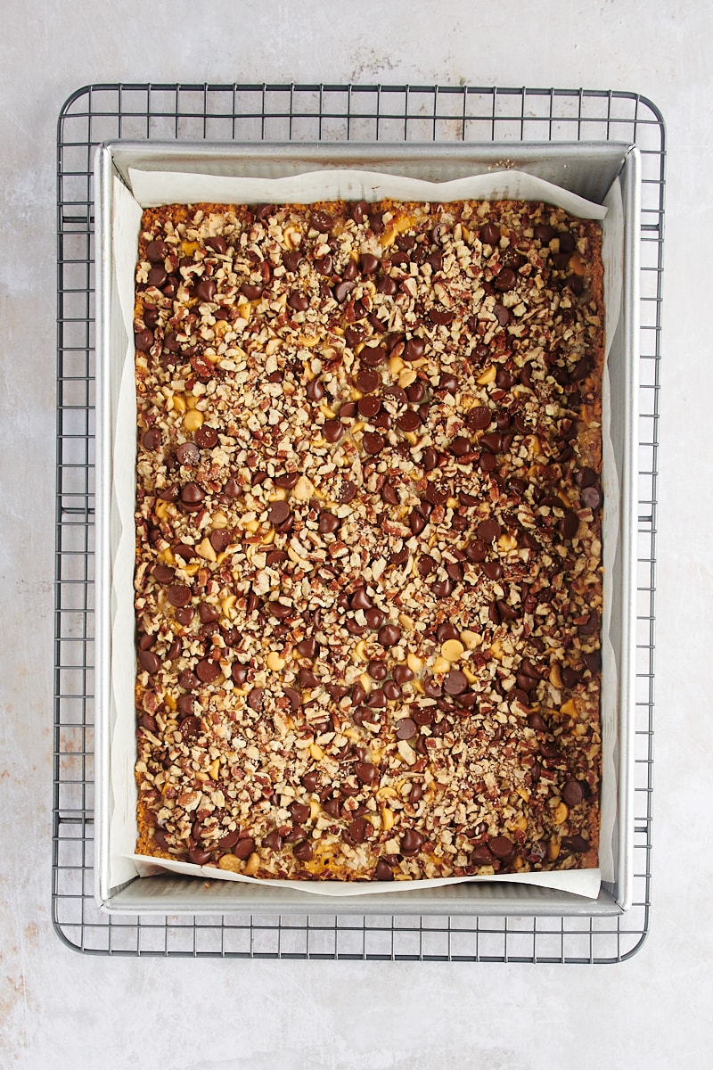 Pan of seven layer bars cooling on wire rack