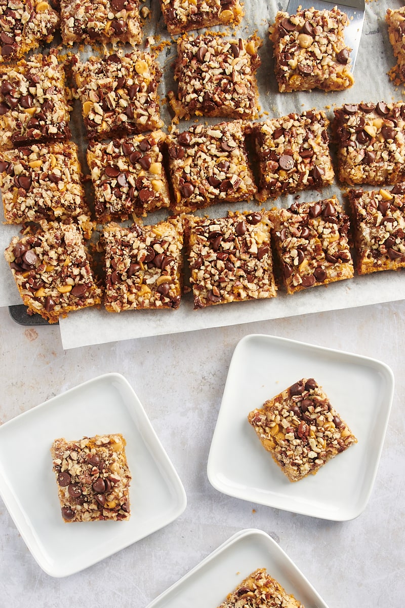 Seven layer bars on parchment paper and white square plates