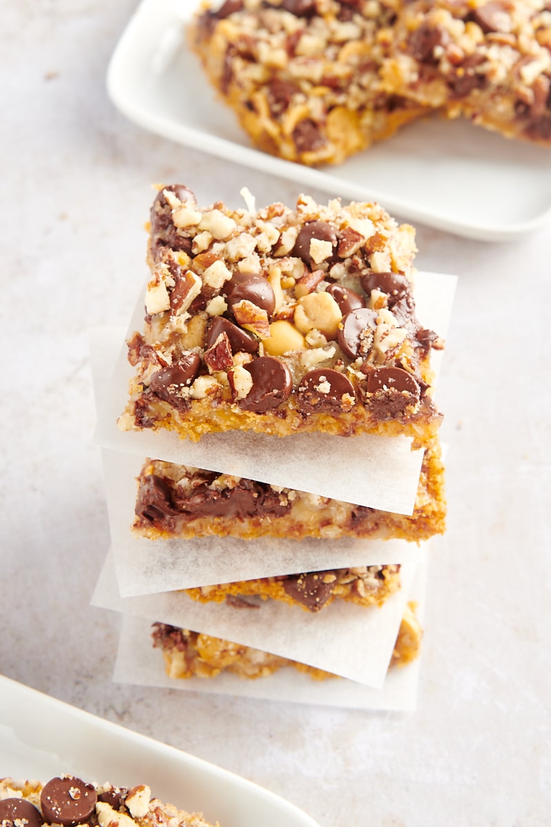 Stack of 4 seven layer bars with parchment paper between each