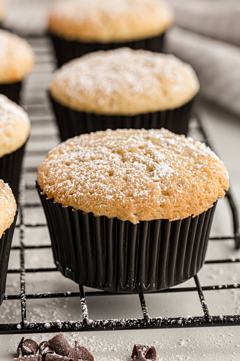 Chocolate-filled cupcakes on cooling rack