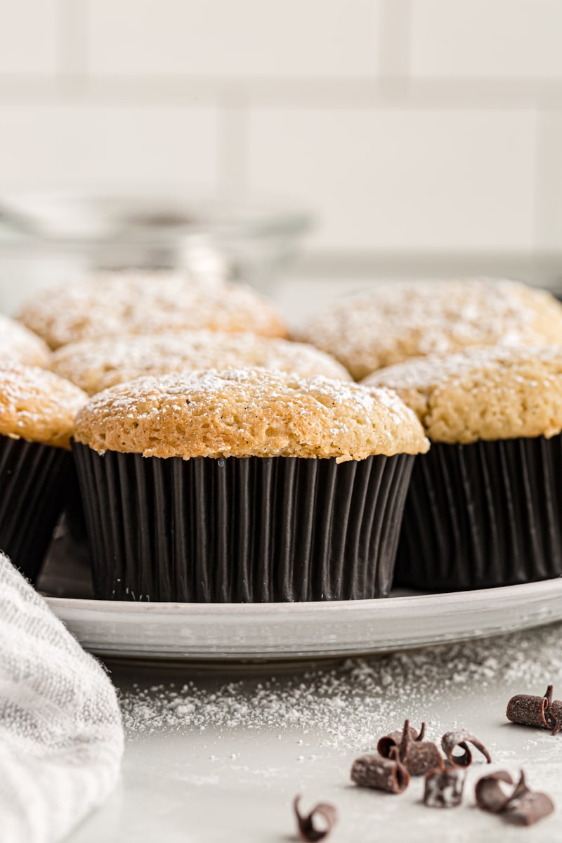 Plate of chocolate-filled cupcakes topped with powdered sugar