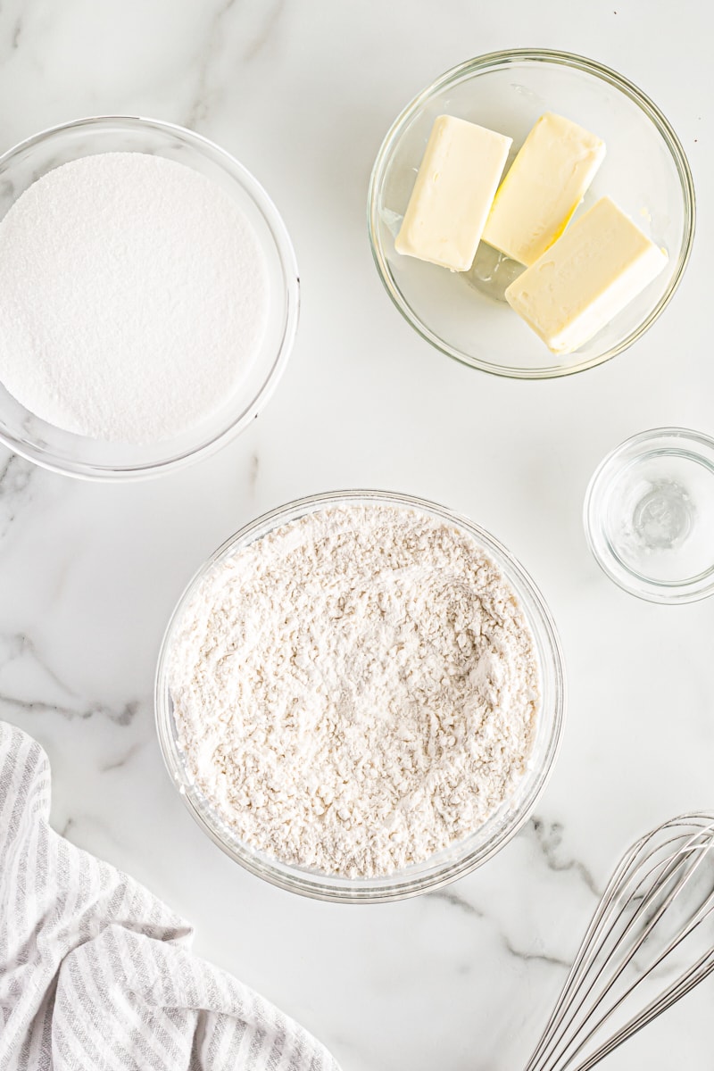 Overhead view of dry ingredients, sugar, and butter in bowls