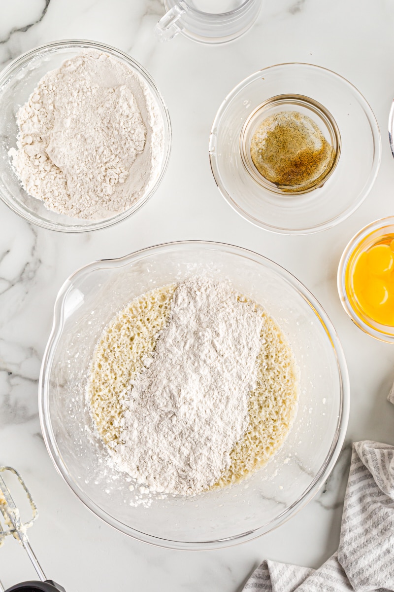 Adding dry ingredients to bowl of wet ingredients