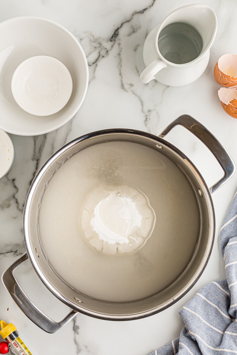 Overhead view of sugar and water in pot